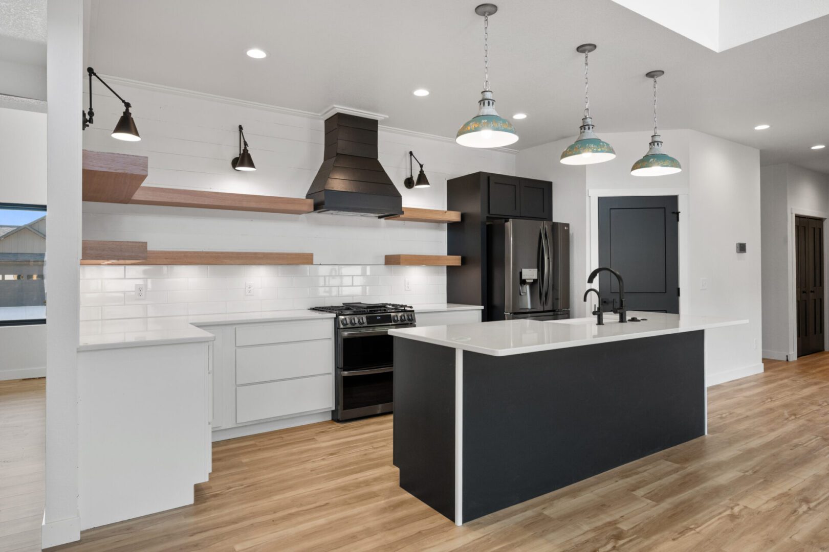 Modern kitchen with a large island and pendant lighting.