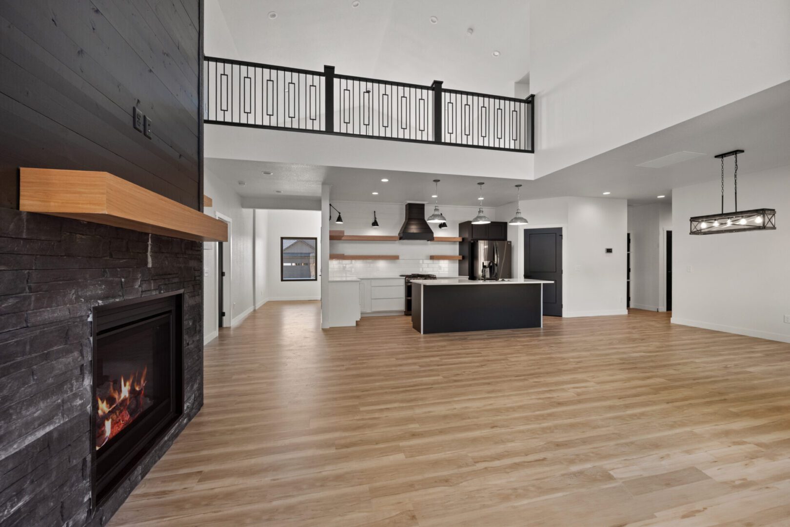 Modern open-concept kitchen with island and hardwood floors.