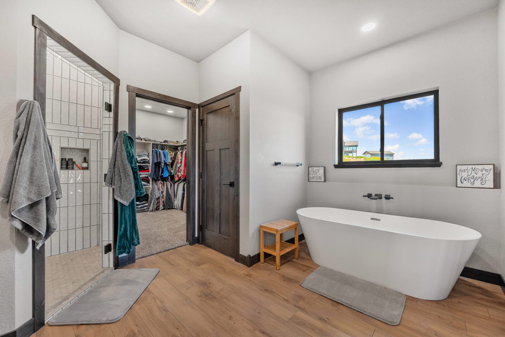 Modern bathroom with a freestanding tub and walk-in closet.