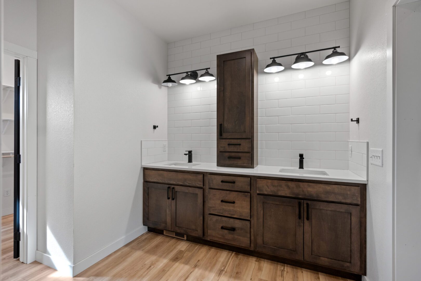 Modern bathroom vanity with dual sinks and dark wood cabinets.