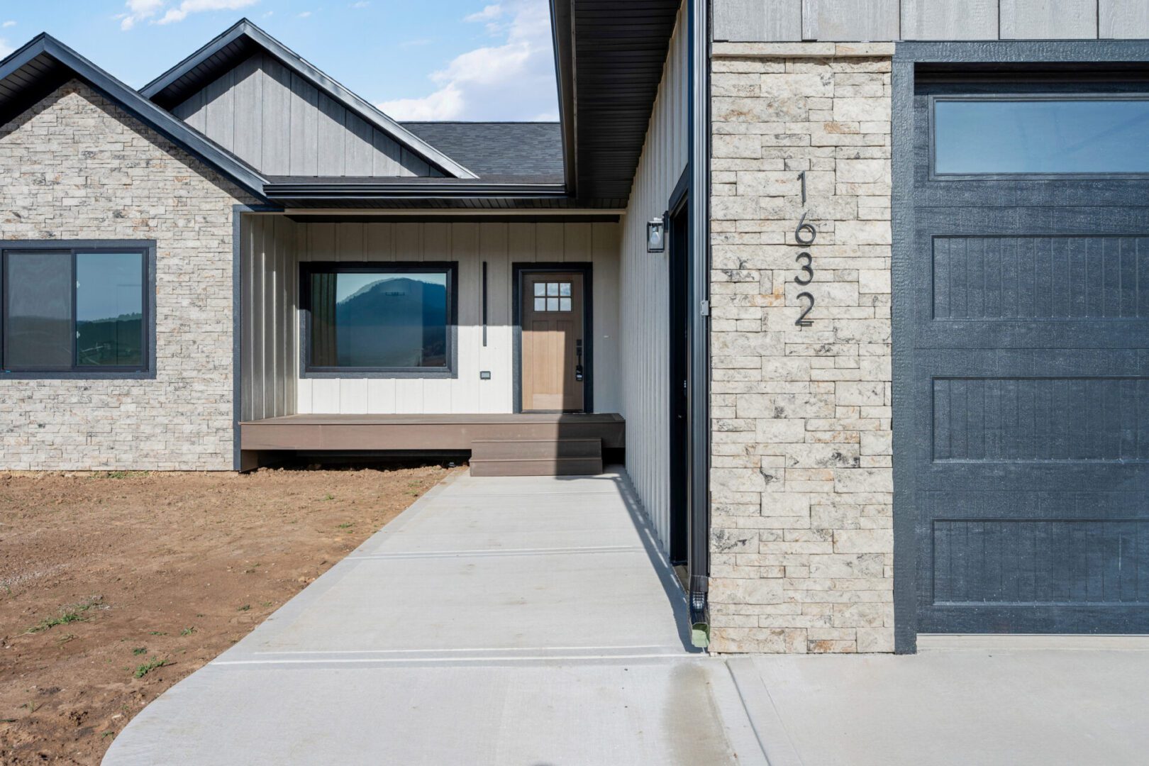 Modern home entrance with stone and wood accents.