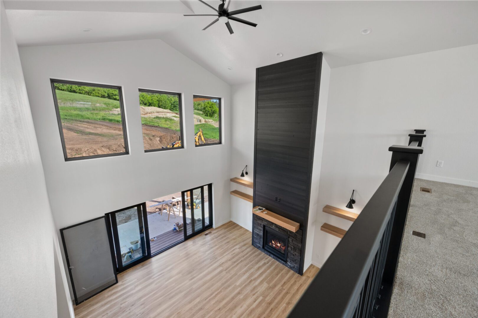 Modern living room with fireplace and large windows.