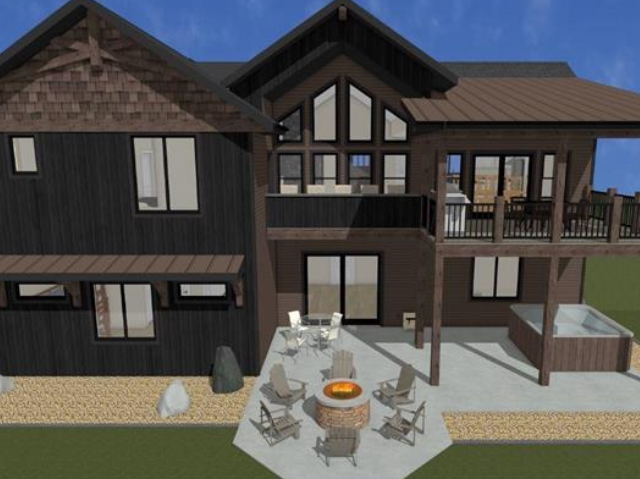 Modern backyard with a cozy fire pit and seating area under clear blue sky.
